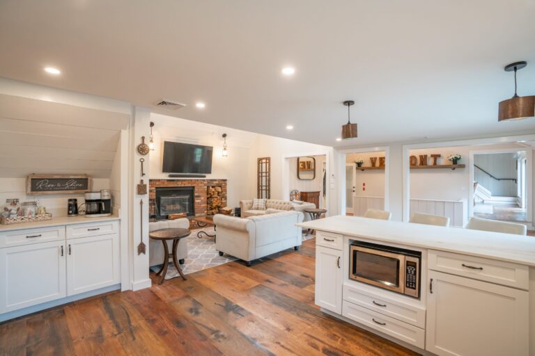 Fully stocked kitchen and living room with fire place and theater TV and sound