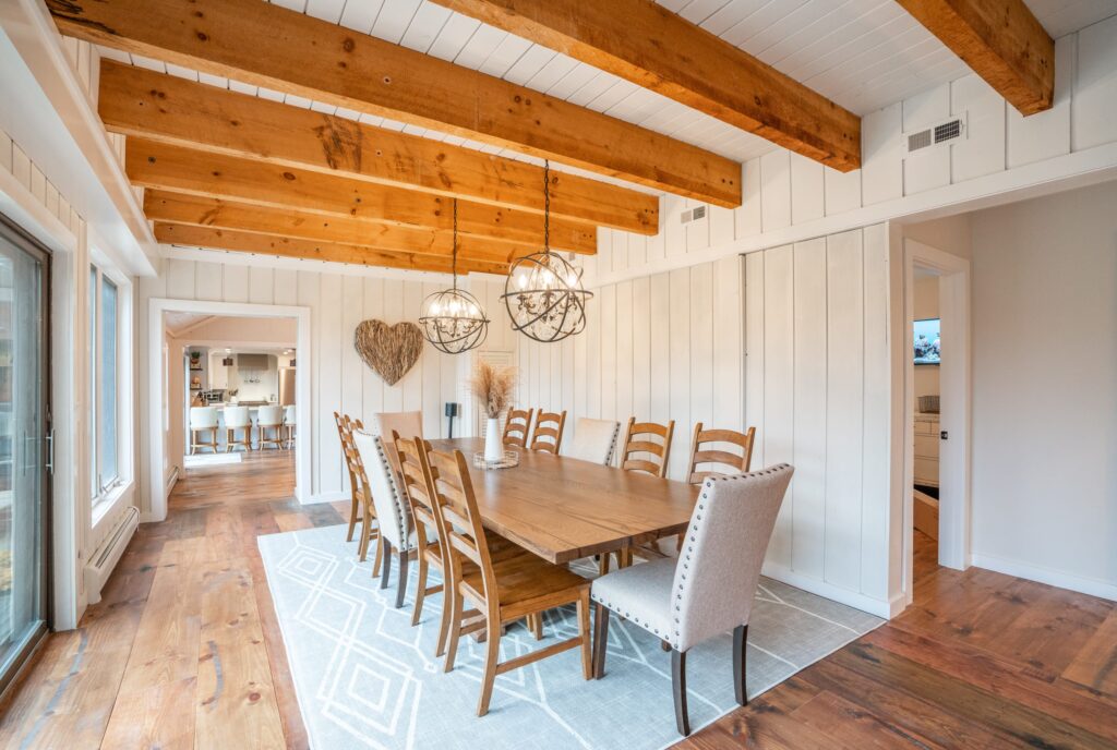 Farmhouse dining room with exposed beams and giant family style dining table