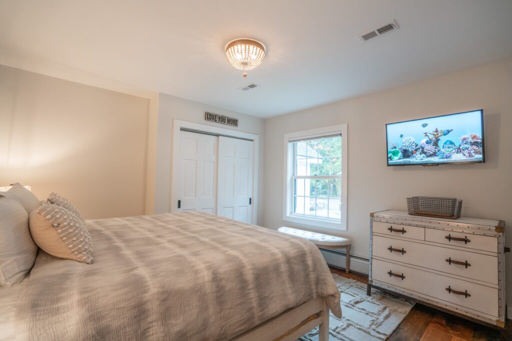 Main floor bedroom with smart TVs and a view