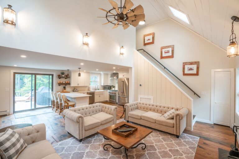 Living room with ship lap walls and cathedral ceilings with fan