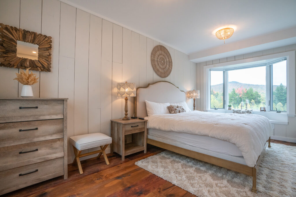 Bohemian bay window bedroom with views of the mountain, pond, and yard