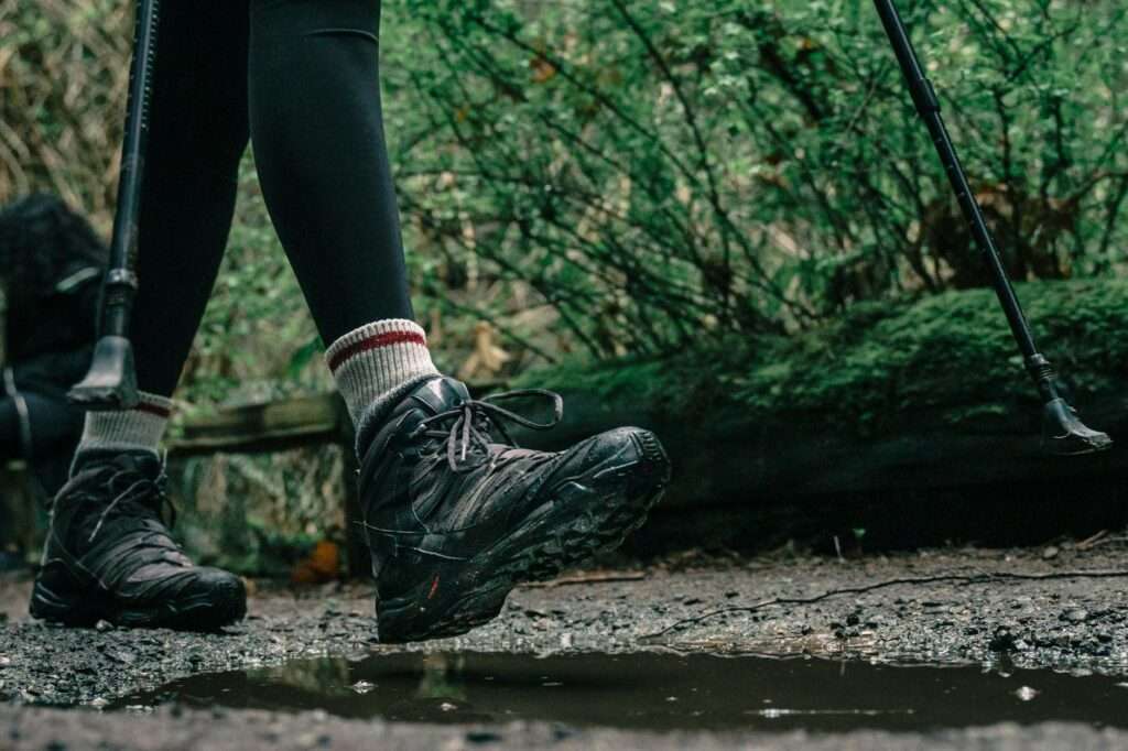 low angle shot of a person wearing hiking shoes